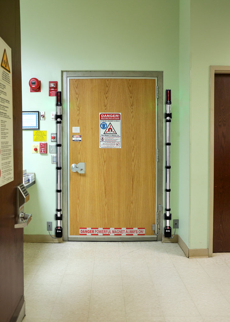 MSDW Plus installed on the sides of an interior hospital door with warning signs of restricted access on the door.  