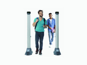 Two people walking through a security screening system, carrying backpacks and personal items, demonstrating fast, non-intrusive checkpoint access.