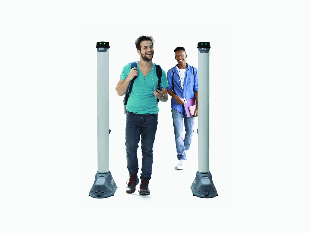 Two people walking through a security screening system, carrying backpacks and personal items, demonstrating fast, non-intrusive checkpoint access.