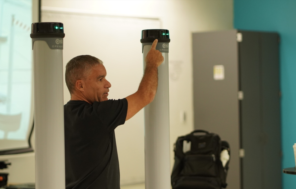 A man pointing to a CEIA Opengate system.